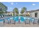 Inviting community swimming pool with comfortable lounge chairs and beautiful palm trees surrounding the area at 1342 Benevolent St, Maitland, FL 32751