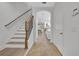 Bright entryway featuring neutral colors, tile floors, and staircase leading to upper level at 1342 Benevolent St, Maitland, FL 32751