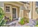 Close up of charming front porch with brick pavers, green wreath, and front door at 1342 Benevolent St, Maitland, FL 32751