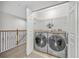Well-equipped laundry room with front loading washer and dryer, storage shelves, folding counter, and natural light at 1342 Benevolent St, Maitland, FL 32751