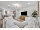 Bright living room featuring an entertainment center and views into the kitchen at 1342 Benevolent St, Maitland, FL 32751