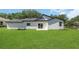New home exterior featuring sliding glass doors opening to a spacious backyard at 1365 Lake Dr, Casselberry, FL 32707