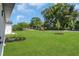 Expansive backyard featuring a lush lawn and newly planted trees at 1365 Lake Dr, Casselberry, FL 32707