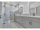 Modern bathroom featuring dual sink vanity, luxurious glass enclosed shower and contemporary finishes at 1365 Lake Dr, Casselberry, FL 32707