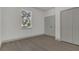Bright bedroom featuring wood-look flooring, neutral walls, large window and closet for ample storage at 1365 Lake Dr, Casselberry, FL 32707