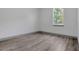 Bright bedroom featuring wood-look flooring, neutral walls and a large window for natural light at 1365 Lake Dr, Casselberry, FL 32707