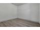 Clean, minimalistic bedroom with white walls and wood-look flooring at 1365 Lake Dr, Casselberry, FL 32707