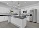 Bright kitchen showcasing white cabinetry, stainless steel appliances, and an island with bar seating at 1365 Lake Dr, Casselberry, FL 32707