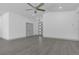 Large living room with white walls, ceiling fan, recessed lighting, and gray flooring at 1365 Lake Dr, Casselberry, FL 32707