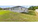 This home features a spacious, grassy backyard and a rear patio at 14953 Sw 38Th Cir, Ocala, FL 34473