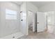 Modern bathroom featuring a tiled walk-in shower with a window for natural light at 14953 Sw 38Th Cir, Ocala, FL 34473