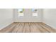 Bright bedroom with laminate flooring and two windows at 14953 Sw 38Th Cir, Ocala, FL 34473