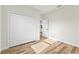 Bedroom featuring laminate flooring and a closet with folding doors at 14953 Sw 38Th Cir, Ocala, FL 34473
