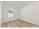 Bright bedroom featuring laminate flooring and a large window at 14953 Sw 38Th Cir, Ocala, FL 34473