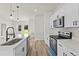 Modern kitchen with white cabinets, stainless steel appliances, a kitchen island, and wood flooring at 14953 Sw 38Th Cir, Ocala, FL 34473