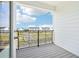 Balcony view of a community with white homes and a street view under a blue sky at 15489 Hamlin Park Drive, Winter Garden, FL 34787