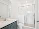 Clean bathroom features a glass shower, white tiling, and a modern vanity at 15489 Hamlin Park Drive, Winter Garden, FL 34787