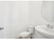 Clean bathroom with a pedestal sink, toilet, and neutral wall color scheme at 15489 Hamlin Park Drive, Winter Garden, FL 34787