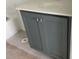 Bathroom featuring gray vanity cabinet with white countertop and modern fixtures at 15489 Hamlin Park Drive, Winter Garden, FL 34787