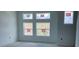 Bright, unfinished bedroom with multiple windows offering ample natural light and scenic neighborhood views at 15489 Hamlin Park Drive, Winter Garden, FL 34787