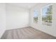 Bright bedroom with neutral carpet and large windows offering ample natural light at 15489 Hamlin Park Drive, Winter Garden, FL 34787