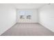 Bright bedroom with carpeted floors and two windows offering natural light at 15489 Hamlin Park Drive, Winter Garden, FL 34787