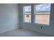 Bright bedroom featuring two windows offering natural light and neighborhood views at 15489 Hamlin Park Drive, Winter Garden, FL 34787