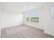Bright bedroom with neutral carpet and two windows offering natural light at 15489 Hamlin Park Drive, Winter Garden, FL 34787