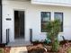 Inviting entryway featuring modern brick accents, sleek black railings, and lush, freshly planted landscaping at 15489 Hamlin Park Drive, Winter Garden, FL 34787