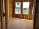 Spacious room with visible framing and window openings in a new house under construction, future bedroom or living space at 15489 Hamlin Park Drive, Winter Garden, FL 34787