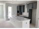 Spacious kitchen featuring grey cabinets and a large center island at 15489 Hamlin Park Drive, Winter Garden, FL 34787