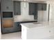 Well-lit kitchen boasting chic gray cabinetry, modern fixtures, and a spacious island for food preparation at 15489 Hamlin Park Drive, Winter Garden, FL 34787