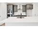 Kitchen island with white countertops, stainless steel appliances, and gray cabinetry at 15489 Hamlin Park Drive, Winter Garden, FL 34787