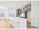 Modern kitchen with a center island, stainless steel appliances, and gray cabinetry at 15489 Hamlin Park Drive, Winter Garden, FL 34787