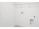 Laundry room features a utility sink, washer and dryer hookups, and a wire shelf at 15489 Hamlin Park Drive, Winter Garden, FL 34787