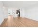 Spacious living room featuring hardwood floors and an open layout to the modern kitchen at 15489 Hamlin Park Drive, Winter Garden, FL 34787