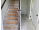 Unfinished staircase with stained banister contrasts with the bright white walls at 15489 Hamlin Park Drive, Winter Garden, FL 34787