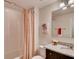 Bathroom featuring a bathtub with a patterned shower curtain and a single sink vanity at 1550 Dalehurst Ln, Kissimmee, FL 34744