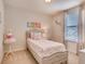 Charming bedroom features a cozy bed with pink accents and a window with natural light at 1550 Dalehurst Ln, Kissimmee, FL 34744