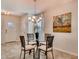 Bright dining area featuring a modern chandelier, seating for four, tile floors, and natural light at 1550 Dalehurst Ln, Kissimmee, FL 34744