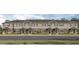 Attractive, three-story townhome with neutral exterior, symmetrical facade, and manicured landscaping providing curb appeal at 1550 Dalehurst Ln, Kissimmee, FL 34744