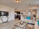 Cozy living room with integrated kitchen and dining area, comfortable seating, and tile flooring for easy maintenance at 1550 Dalehurst Ln, Kissimmee, FL 34744