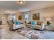 Open-concept living room featuring tile floors, coordinated furnishings, neutral color scheme, and access to dining area at 1550 Dalehurst Ln, Kissimmee, FL 34744