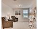 Bright sitting room with decor, comfortable chairs and a large window at 1550 Dalehurst Ln, Kissimmee, FL 34744