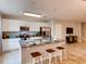 Modern kitchen boasting an island with breakfast bar and stainless steel appliances at 1554 Dalehurst Ln, Kissimmee, FL 34744
