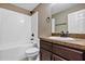 Well-lit bathroom with a shower/tub combo, and a vanity with dark cabinets at 1883 Sw 160Th Pl, Ocala, FL 34473