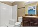 Cozy bathroom with a white tiled shower, toilet, and dark wood vanity with a light countertop at 1883 Sw 160Th Pl, Ocala, FL 34473