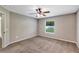 Neutral bedroom featuring a ceiling fan, carpeted floors, and a window for natural light at 1883 Sw 160Th Pl, Ocala, FL 34473