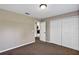 Cozy bedroom with closet doors, carpeted floors, and an open doorway at 1883 Sw 160Th Pl, Ocala, FL 34473