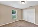 Comfortable bedroom with closet doors, cozy carpet, and a bright window view at 1883 Sw 160Th Pl, Ocala, FL 34473